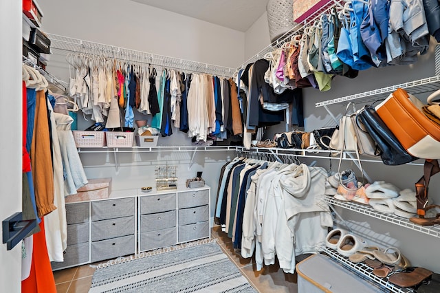 spacious closet with tile patterned floors