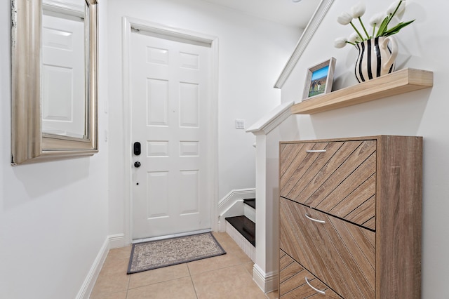 entryway with light tile patterned floors and baseboards