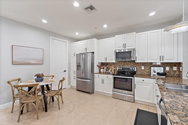 kitchen featuring tasteful backsplash, visible vents, a sink, and appliances with stainless steel finishes