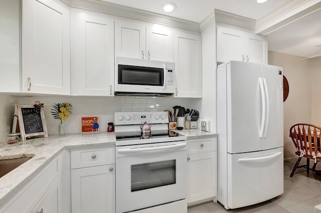 815 Club Dr Unit D, Delray Beach, FL 33445 - kitchen with white appliances, white cabinetry, light stone countertops, light tile patterned floors, and recessed lighting