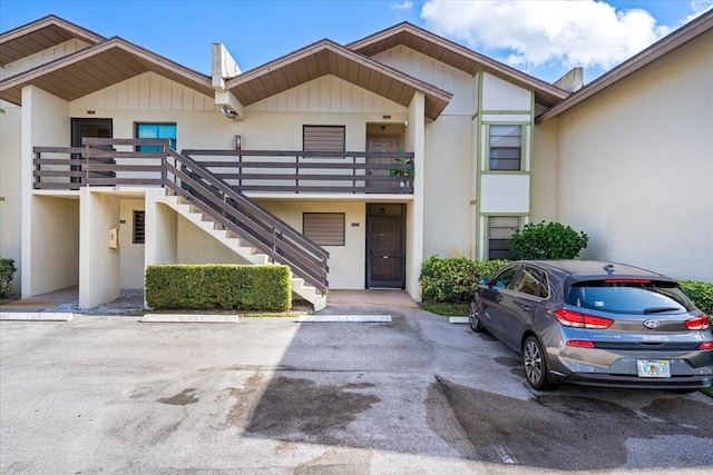 1811 SW Palm City Rd Unit A-202, Stuart, FL 34994 - view of property featuring stairway and uncovered parking