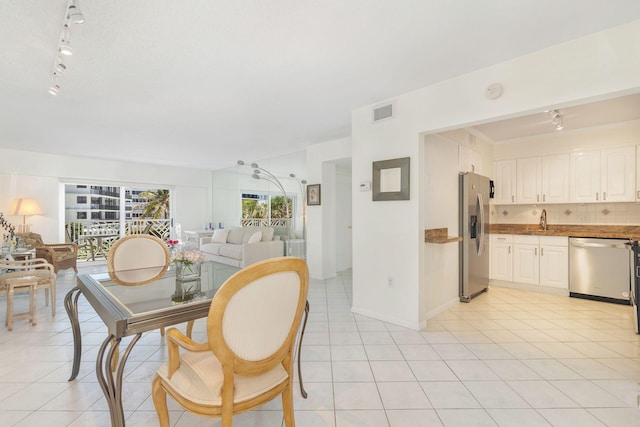 170 N Ocean Blvd Unit 305, Palm Beach, FL 33480 - dining area with track lighting, light tile patterned floors, baseboards, and visible vents