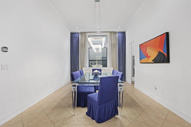 dining space featuring ornamental molding, a chandelier, light tile patterned flooring, and baseboards