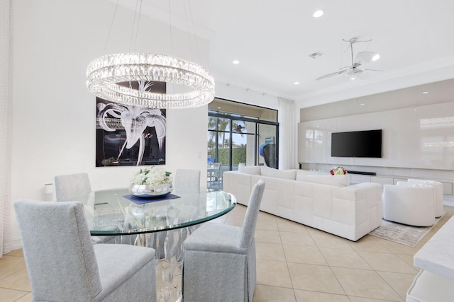tiled dining space with ornamental molding, recessed lighting, a chandelier, and a ceiling fan