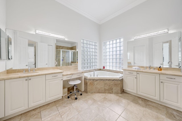bathroom featuring ornamental molding, a shower stall, a garden tub, two vanities, and tile patterned floors