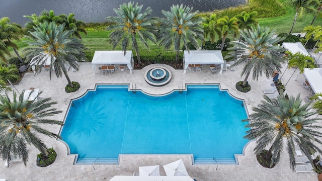 community pool with a gazebo, a patio, and outdoor dining space