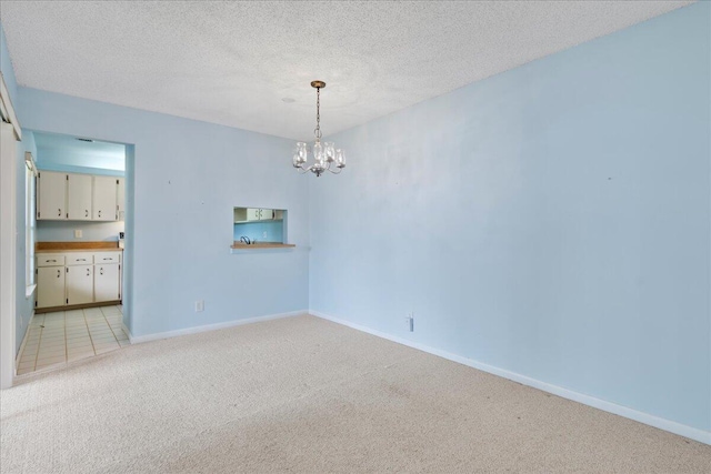 6117 Woodlake Blvd, Greenacres, FL 33463 - empty room with light colored carpet, a chandelier, baseboards, and a textured ceiling