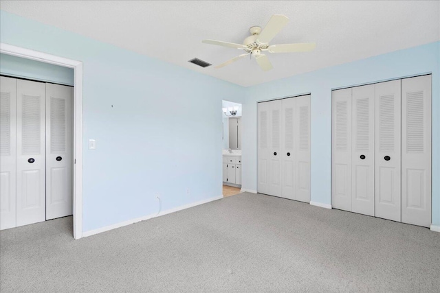 6117 Woodlake Blvd, Greenacres, FL 33463 - unfurnished bedroom with carpet floors, two closets, baseboards, and ceiling fan