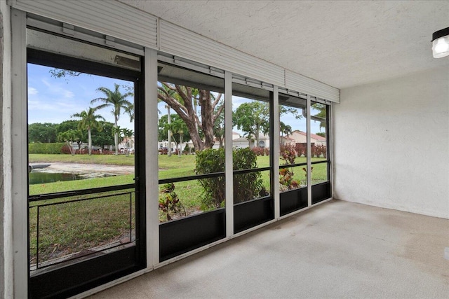 6117 Woodlake Blvd, Greenacres, FL 33463 - unfurnished sunroom with a textured ceiling and carpet flooring