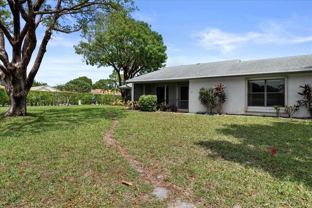 6117 Woodlake Blvd, Greenacres, FL 33463 - view of grassy yard with a sunroom