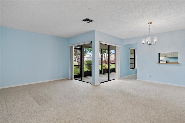 6117 Woodlake Blvd, Greenacres, FL 33463 - carpeted spare room with a chandelier, baseboards, and a textured ceiling