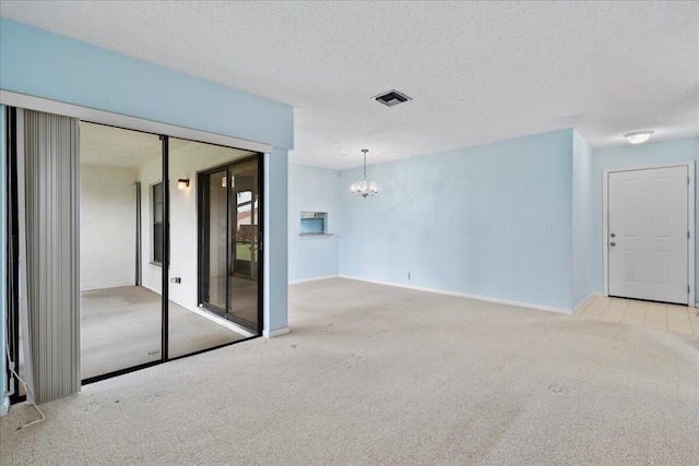 6117 Woodlake Blvd, Greenacres, FL 33463 - carpeted spare room with a chandelier, a textured ceiling, and baseboards