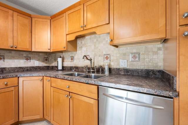 kitchen featuring dishwasher, a sink, backsplash, and dark countertops