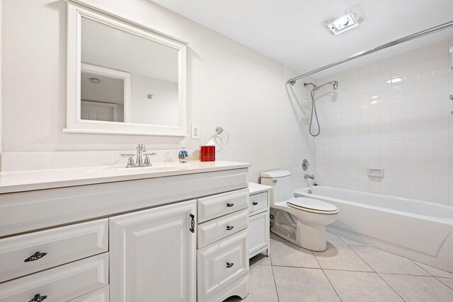 full bathroom featuring toilet, tile patterned floors, vanity, and shower / bath combination