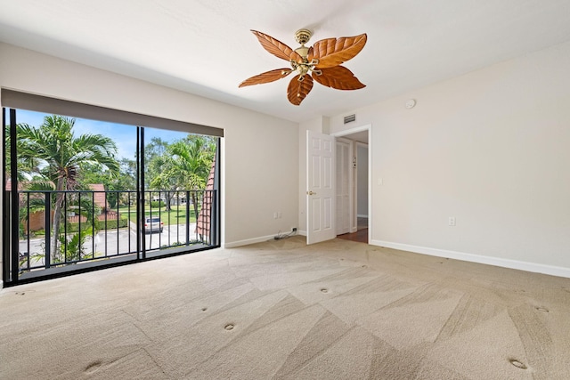 unfurnished room featuring visible vents, baseboards, a ceiling fan, and carpet flooring