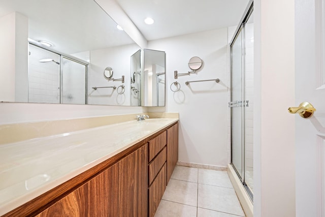 bathroom featuring tile patterned floors, a stall shower, and vanity
