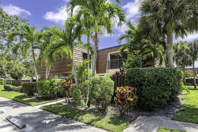 obstructed view of property featuring fence and brick siding