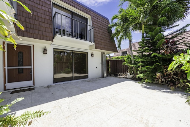 view of patio / terrace featuring a balcony and fence