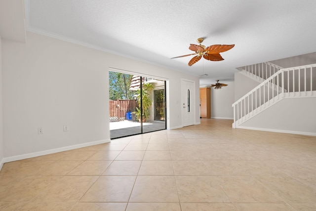 unfurnished living room featuring baseboards, stairway, light tile patterned floors, a textured ceiling, and ceiling fan