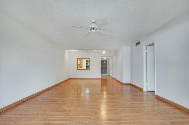 1852 SW Palm City Rd Unit 202, Stuart, FL 34994 - spare room with light wood-style floors, ceiling fan, and track lighting
