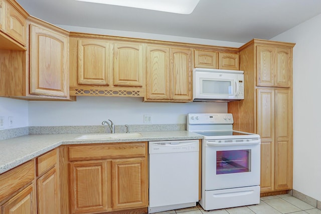 1852 SW Palm City Rd Unit 202, Stuart, FL 34994 - kitchen featuring white appliances, light countertops, light brown cabinets, and light tile patterned floors