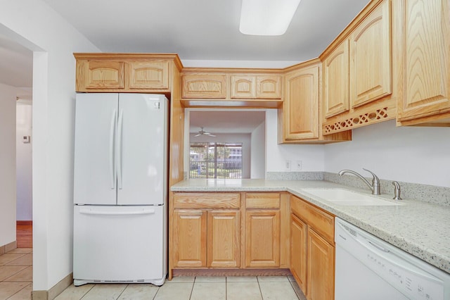 1852 SW Palm City Rd Unit 202, Stuart, FL 34994 - kitchen with white appliances, light tile patterned floors, light stone counters, and light brown cabinetry
