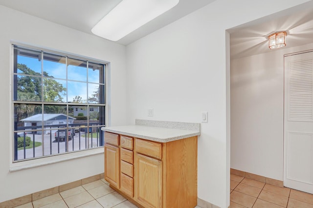 1852 SW Palm City Rd Unit 202, Stuart, FL 34994 - kitchen with light tile patterned floors and light brown cabinets