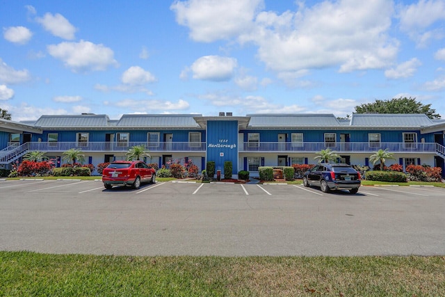 1852 SW Palm City Rd Unit 202, Stuart, FL 34994 - view of building exterior featuring uncovered parking and a residential view