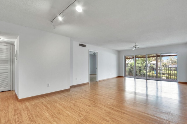 1852 SW Palm City Rd Unit 202, Stuart, FL 34994 - unfurnished room with rail lighting, a ceiling fan, and light wood-style flooring