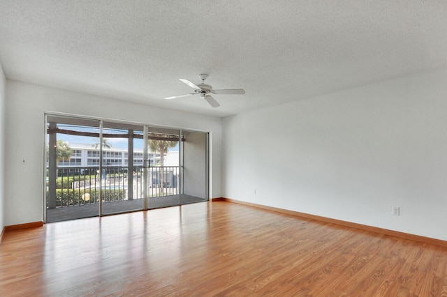 1852 SW Palm City Rd Unit 202, Stuart, FL 34994 - empty room featuring wood finished floors, a textured ceiling, and ceiling fan