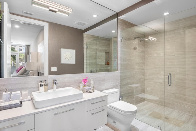 3200 S Ocean Blvd Unit 101, Highland Beach, FL 33487 - full bath with toilet, a stall shower, vanity, and tile walls