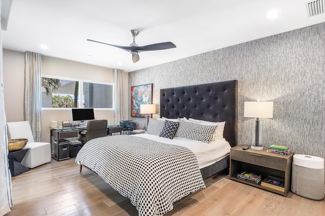 3200 S Ocean Blvd Unit 101, Highland Beach, FL 33487 - bedroom featuring wallpapered walls, an accent wall, an office area, wood finished floors, and recessed lighting