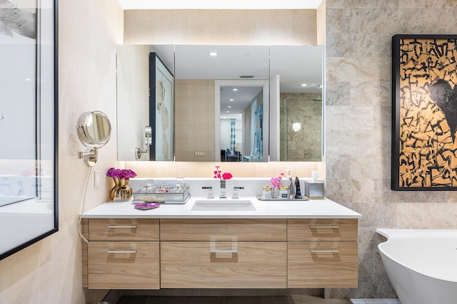3200 S Ocean Blvd Unit 101, Highland Beach, FL 33487 - bathroom with tile walls, vanity, a freestanding bath, and tiled shower