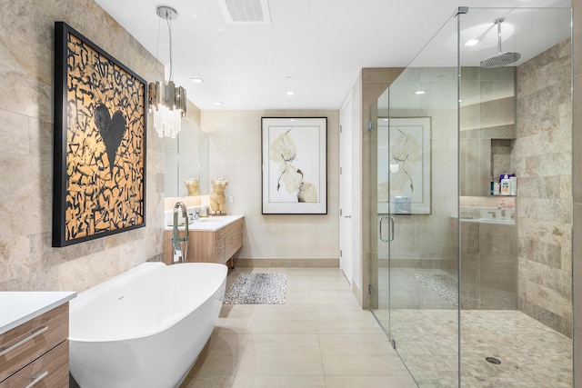 3200 S Ocean Blvd Unit 101, Highland Beach, FL 33487 - bathroom featuring a stall shower, vanity, a freestanding tub, tile patterned floors, and baseboards