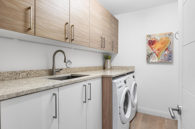3200 S Ocean Blvd Unit 101, Highland Beach, FL 33487 - laundry area with washer and clothes dryer, cabinet space, light wood-style floors, and baseboards