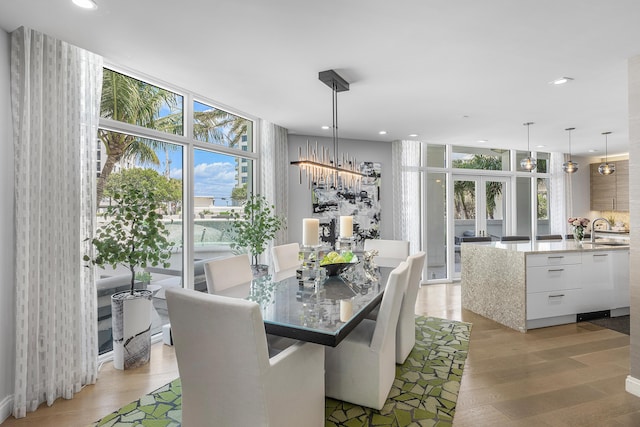 3200 S Ocean Blvd Unit 101, Highland Beach, FL 33487 - dining area featuring a wall of windows, healthy amount of natural light, light wood finished floors, a chandelier, and recessed lighting