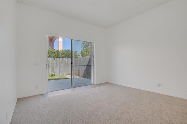 unfurnished room with baseboards and carpet flooring