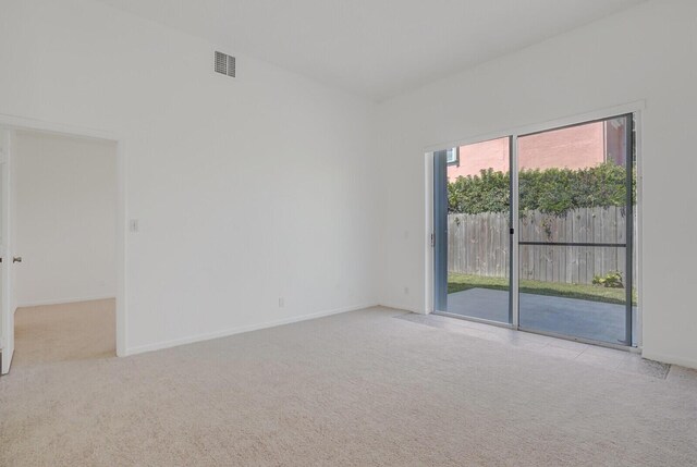 carpeted empty room with visible vents and baseboards
