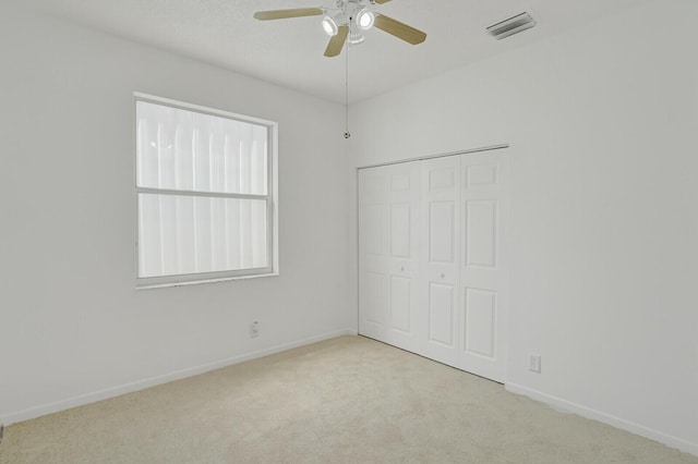 unfurnished bedroom featuring carpet, visible vents, and baseboards