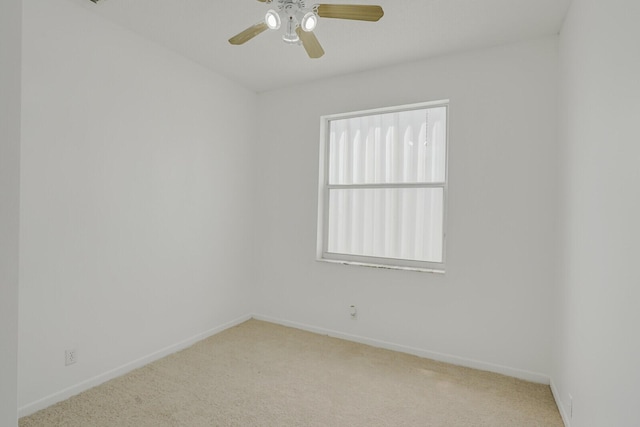carpeted empty room with baseboards and ceiling fan