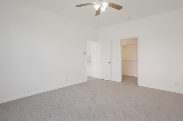 empty room with baseboards, a ceiling fan, and carpet