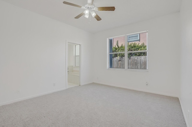carpeted empty room featuring baseboards and a ceiling fan