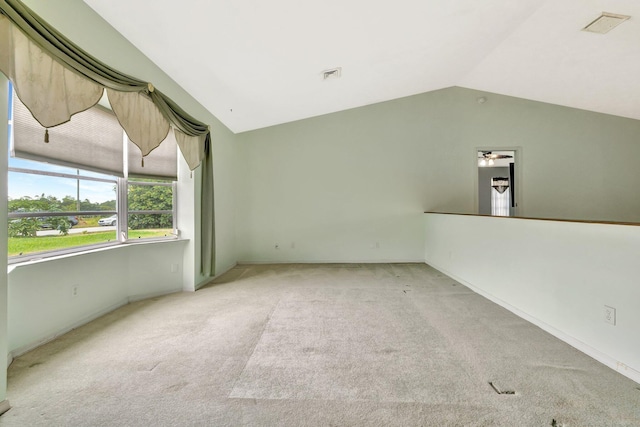 unfurnished room featuring carpet floors, visible vents, and lofted ceiling