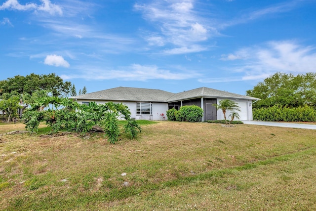 ranch-style home featuring an attached garage, driveway, and a front lawn