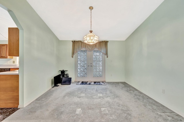 unfurnished dining area with french doors, baseboards, and carpet floors