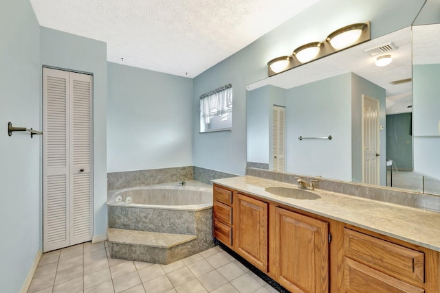 full bath featuring a closet, tile patterned flooring, visible vents, vanity, and a bath