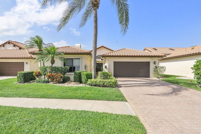 22652 Esplanada Cir W, Boca Raton, FL 33433 - mediterranean / spanish-style house with an attached garage, stucco siding, driveway, a front yard, and a tile roof