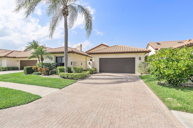 22652 Esplanada Cir W, Boca Raton, FL 33433 - mediterranean / spanish house featuring stucco siding, a tiled roof, a garage, decorative driveway, and a front yard