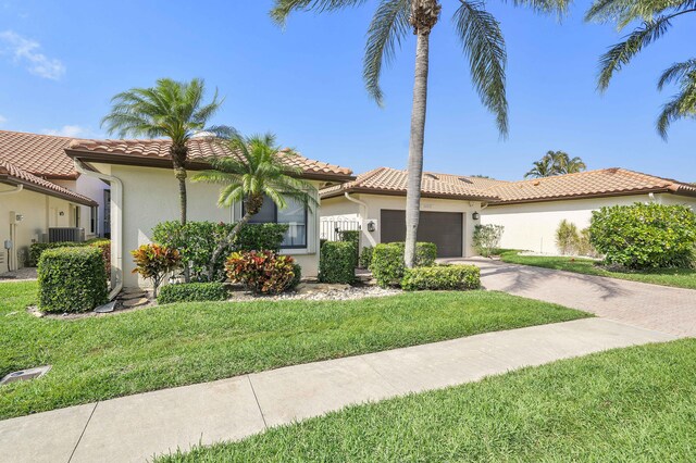 22652 Esplanada Cir W, Boca Raton, FL 33433 - mediterranean / spanish-style home with stucco siding, a garage, concrete driveway, and central AC