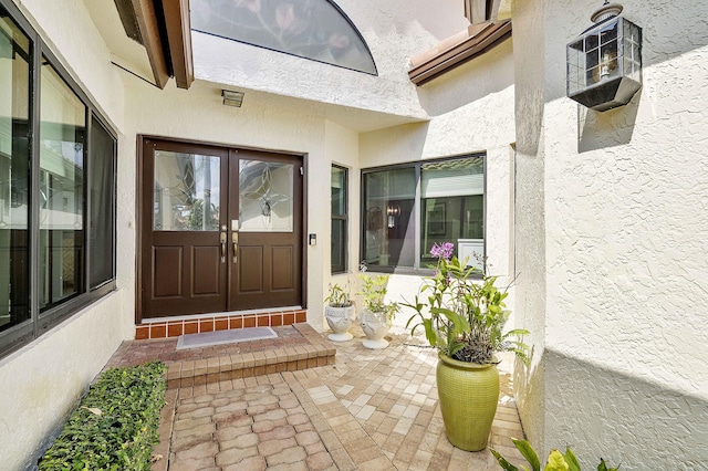 22652 Esplanada Cir W, Boca Raton, FL 33433 - view of exterior entry featuring stucco siding and french doors